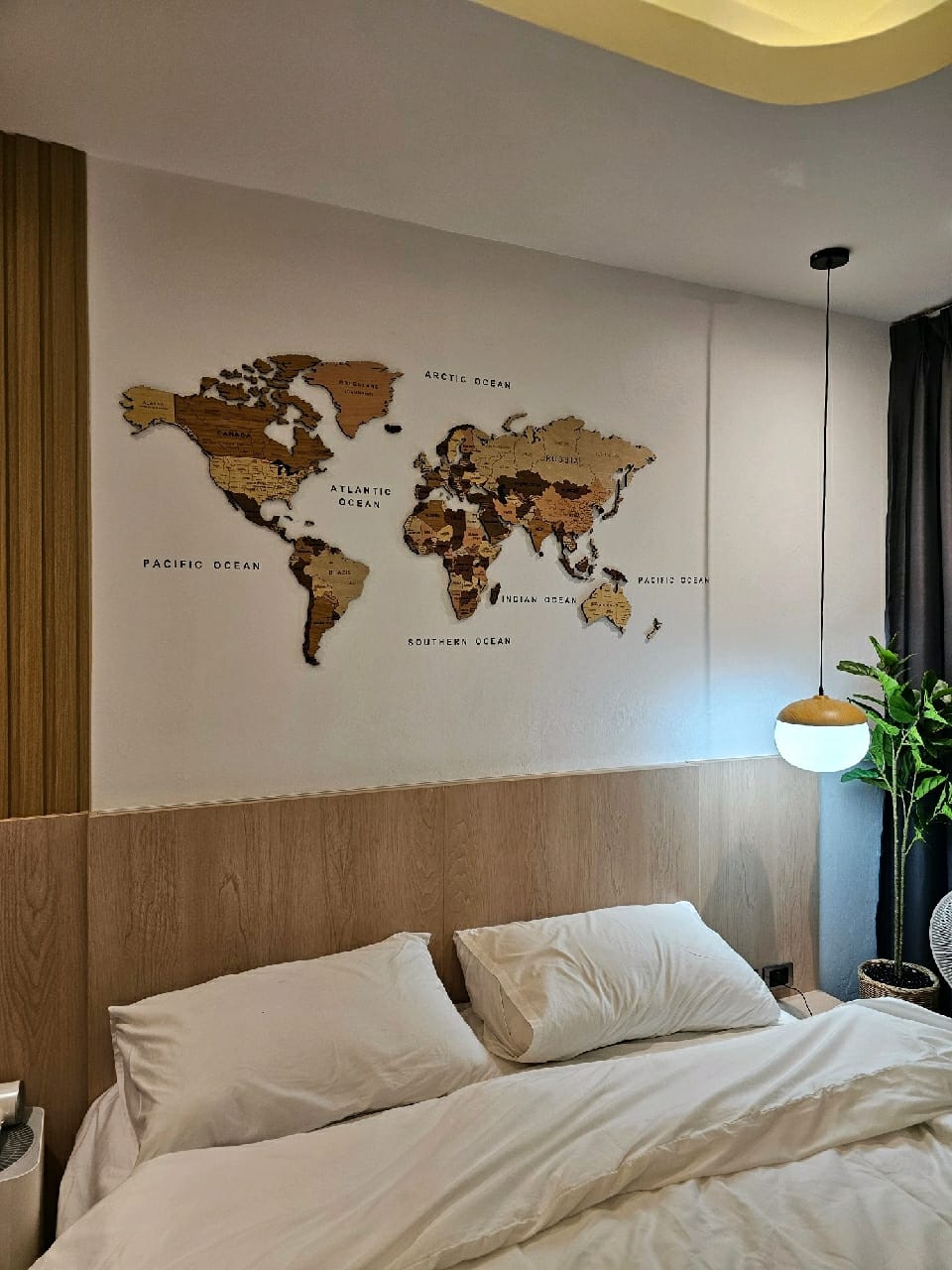 EgoWooden wooden world map installed above a bed